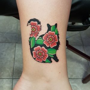 Traditional style red flowers inside of a fluffy cat silhouette.