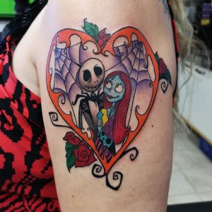 Jack and Sally from the Nightmare before Christmas, inside of an orange heart with roses and spiderwebs.