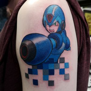 Megaman about to fire cannon with pixels breaking up near the bottom on the tattoo