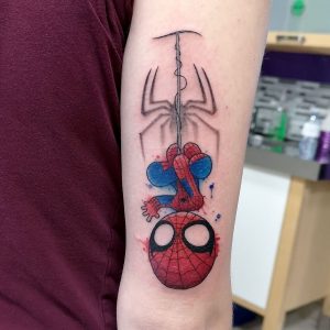 Chibi style Spiderman with watercolouring hanging from web coming out of skin. Gray-scale spider symbol in background.